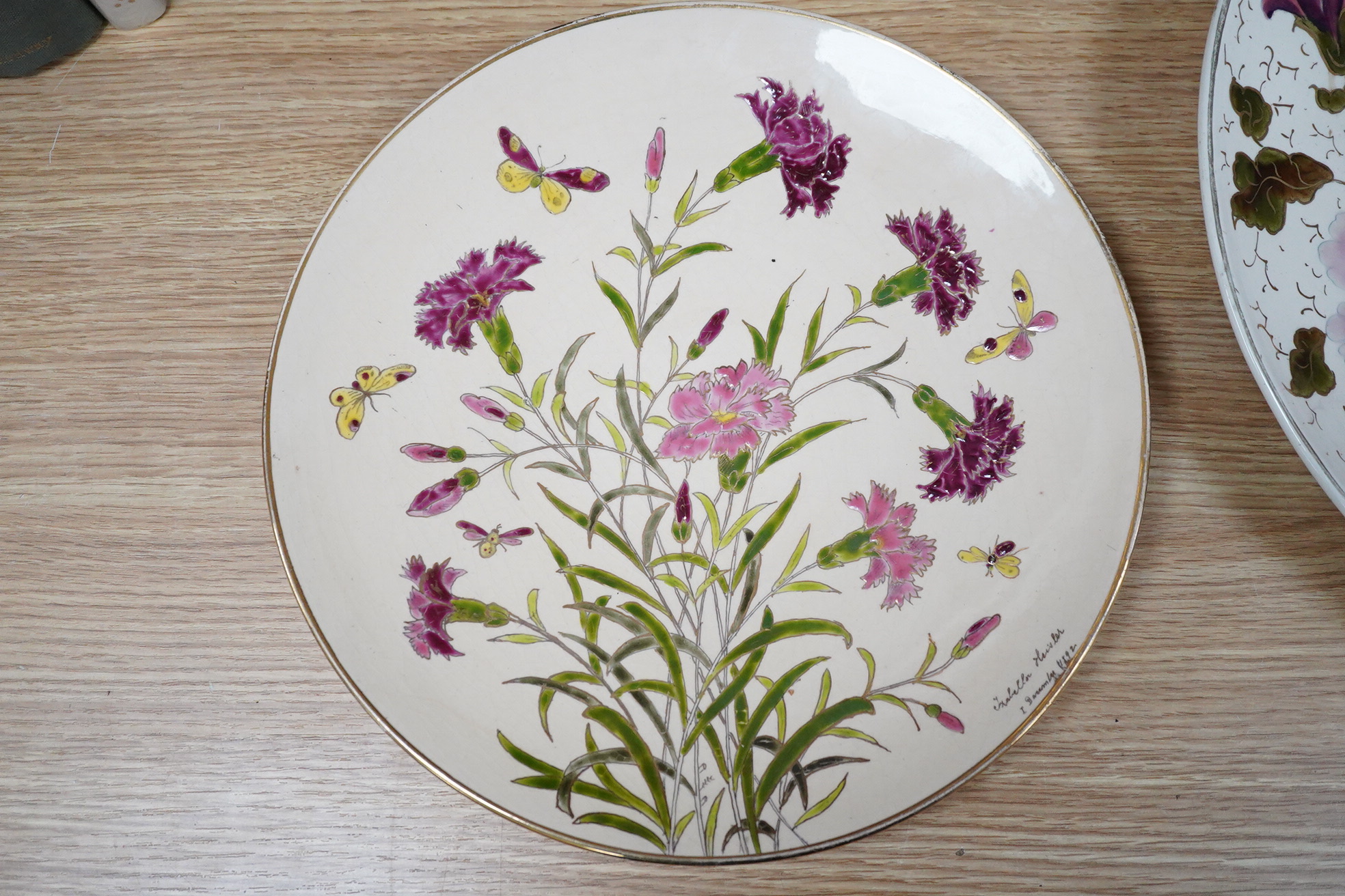 A Zsolnay-type floral charger, 39cm diameter and similar smaller Schutz Cilli plate